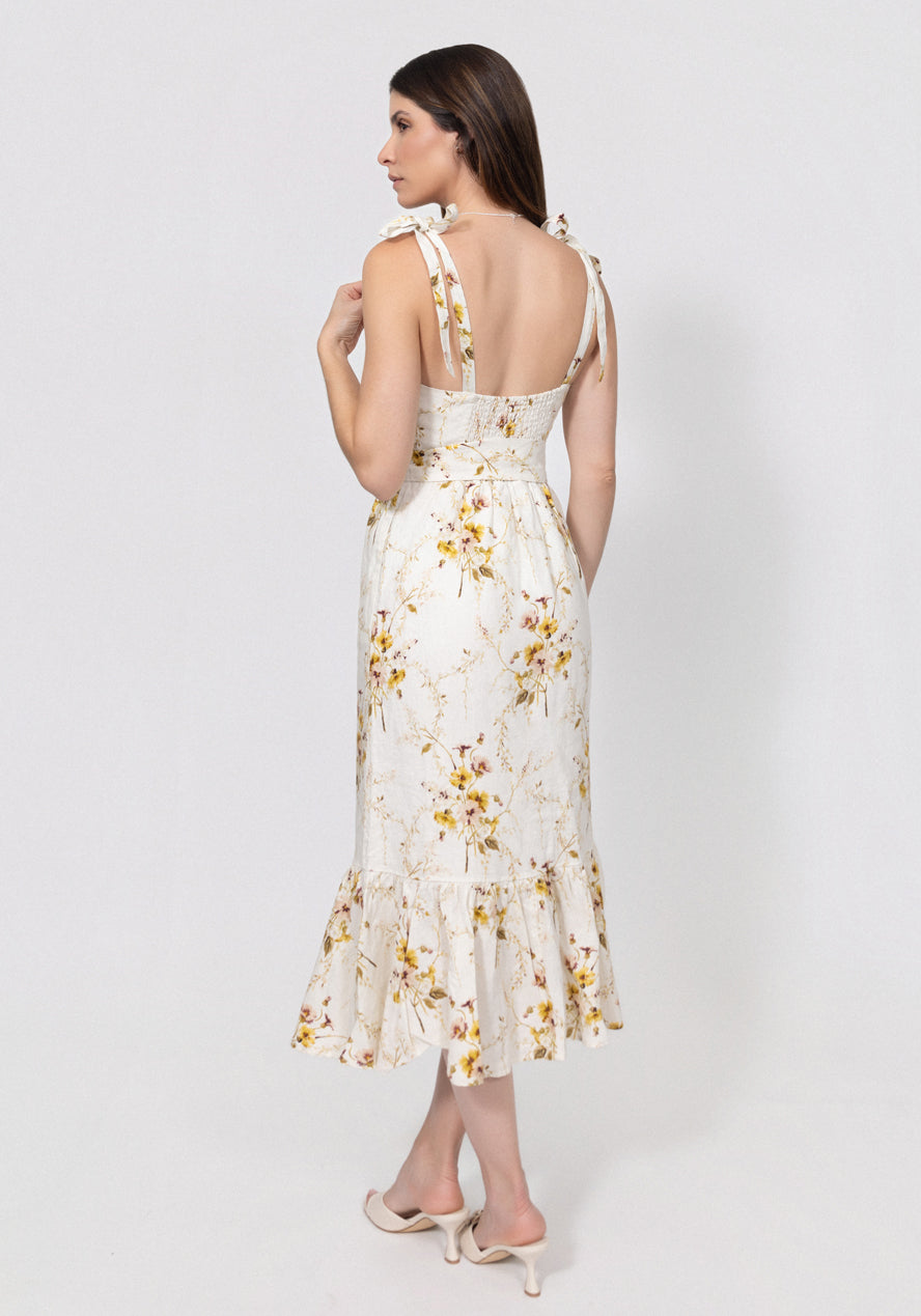 Woman wearing a floral linen dress on a white background