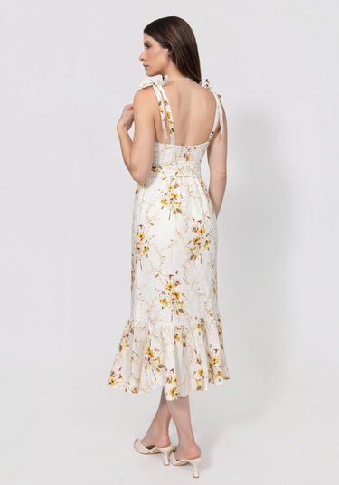 Woman wearing a floral linen dress on a white background