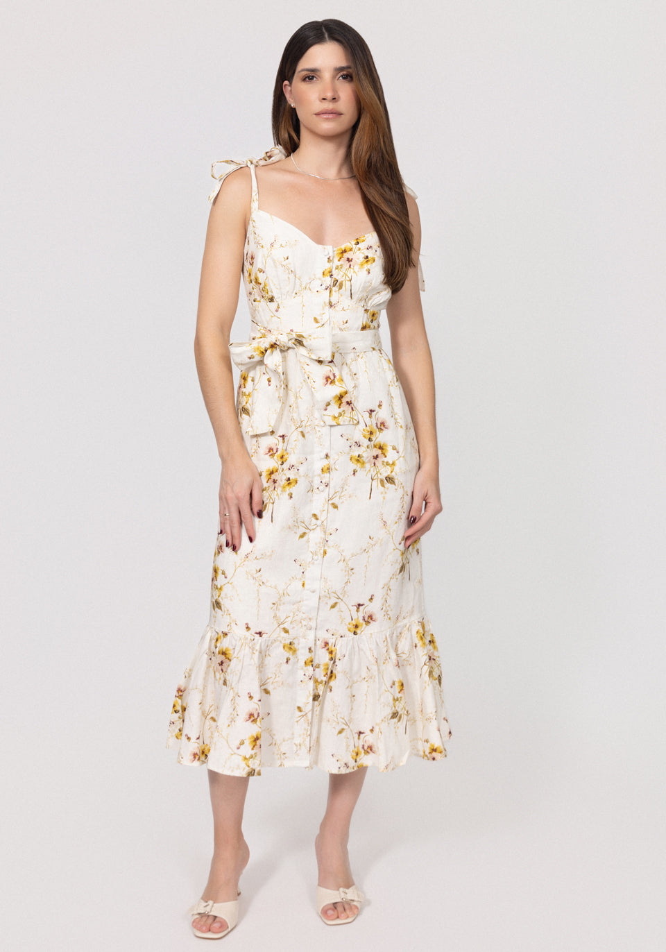 Woman wearing a floral linen dress on a white background