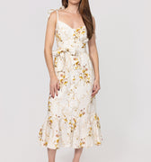 Woman wearing a floral linen dress on a white background