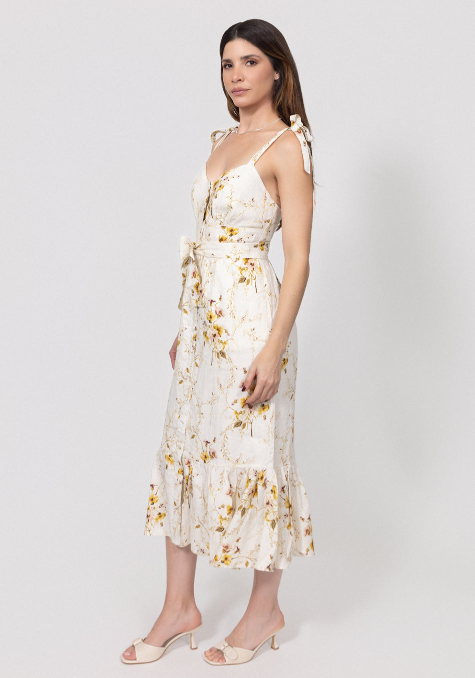 Woman wearing a floral linen dress on a white background