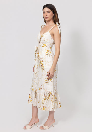 Woman wearing a floral linen dress on a white background
