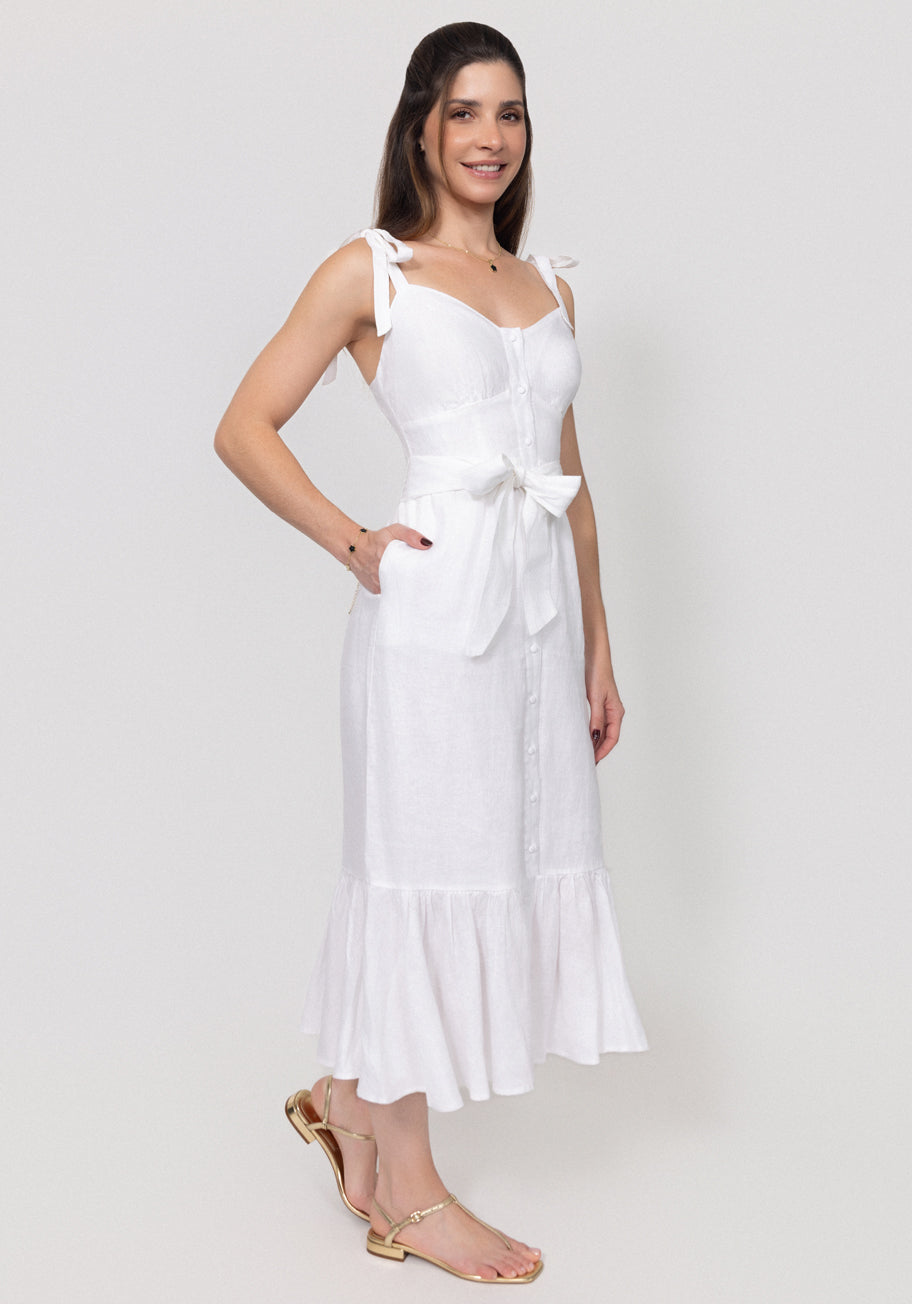 Woman wearing a white Buttoned Linen Midi Dress With Tie Straps and Ruffled Hem with a plain background