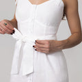 White dress with bow straps on a plain background