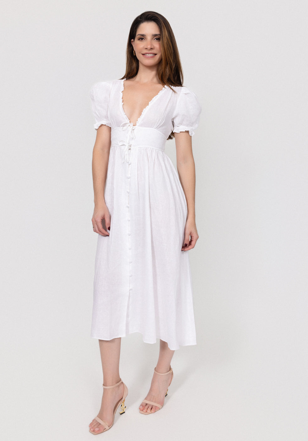 Woman wearing a white Linen Button-Front Midi Dress with Puff Sleeves & Tie Detail against a plain background