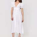 Woman wearing a white Linen Button-Front Midi Dress with Puff Sleeves & Tie Detail against a plain background