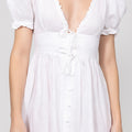 White dress with puff sleeves on a plain background