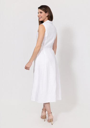 Woman wearing a white linen sleeveless dress on a plain background