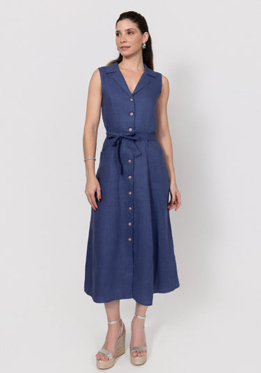 Woman wearing a navy blue linen dress with buttons on a white background