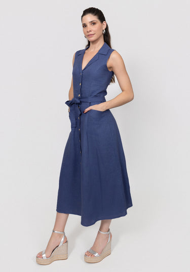 Woman wearing a navy blue linen button dress with a white background