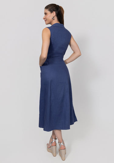 Woman wearing a navy blue linen dress with pockets on a white background