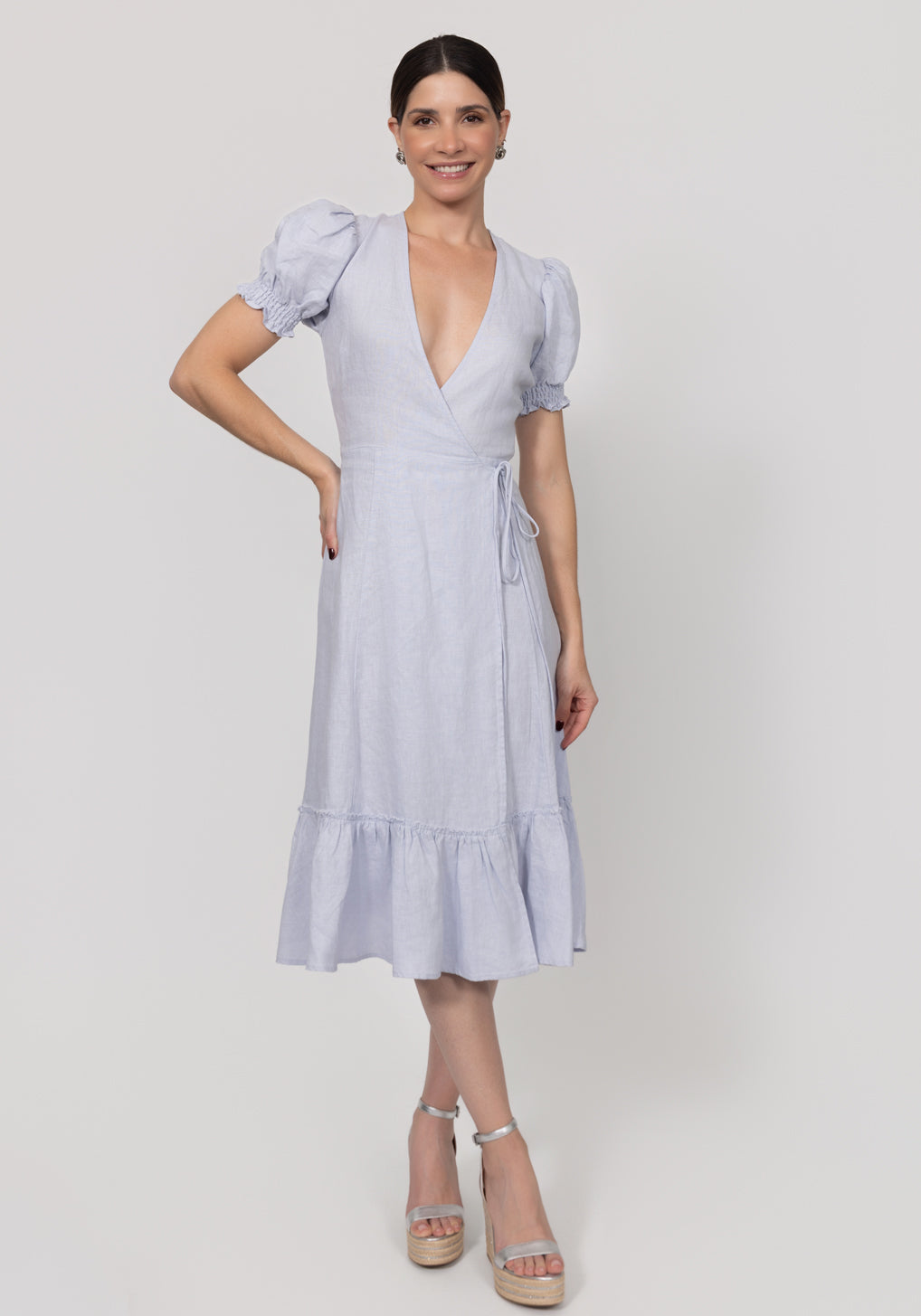 Woman wearing a light blue dress on a white background