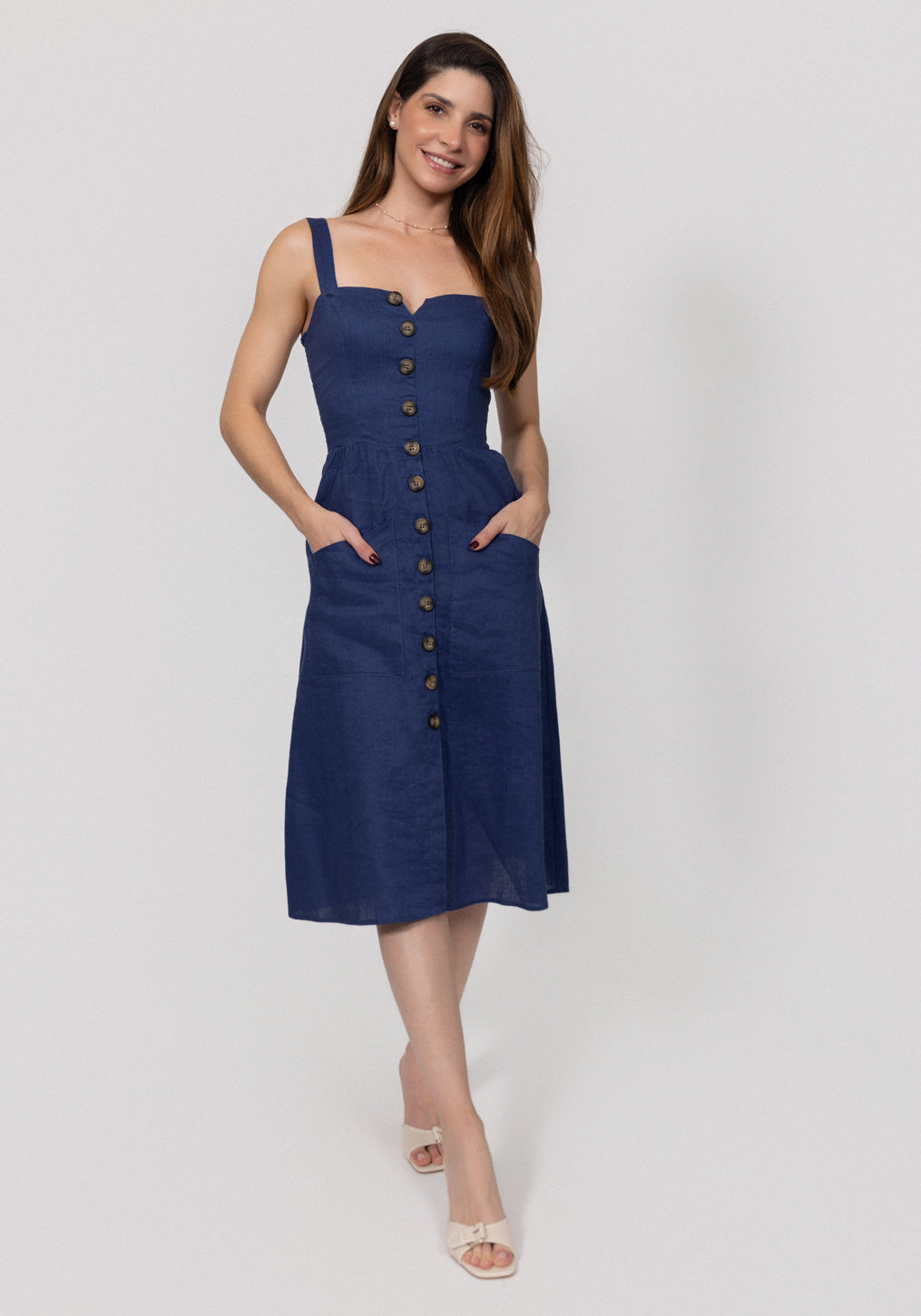 Woman wearing a navy blue Midi Linen Dress With Front Buttons & Pockets with buttons on a white background