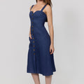 Woman wearing a blue Midi Linen Dress With Front Buttons & Pockets with button details on a white background
