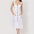 Woman wearing a white Midi Linen Dress With Front Buttons & Pockets with buttons on a plain background
