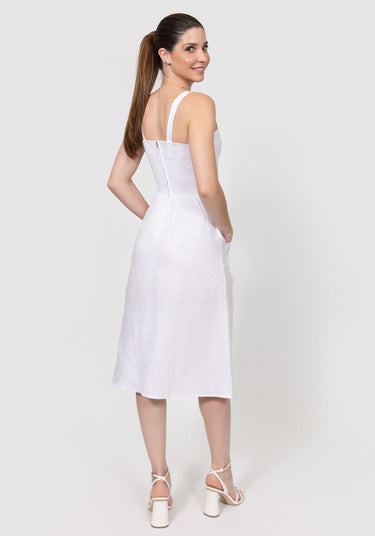 Woman wearing a white dress on a plain background