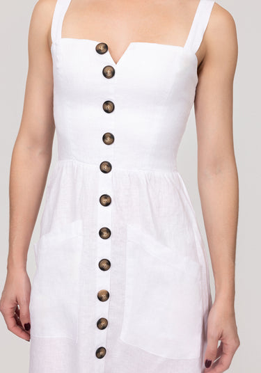 White dress with brown buttons on a plain background