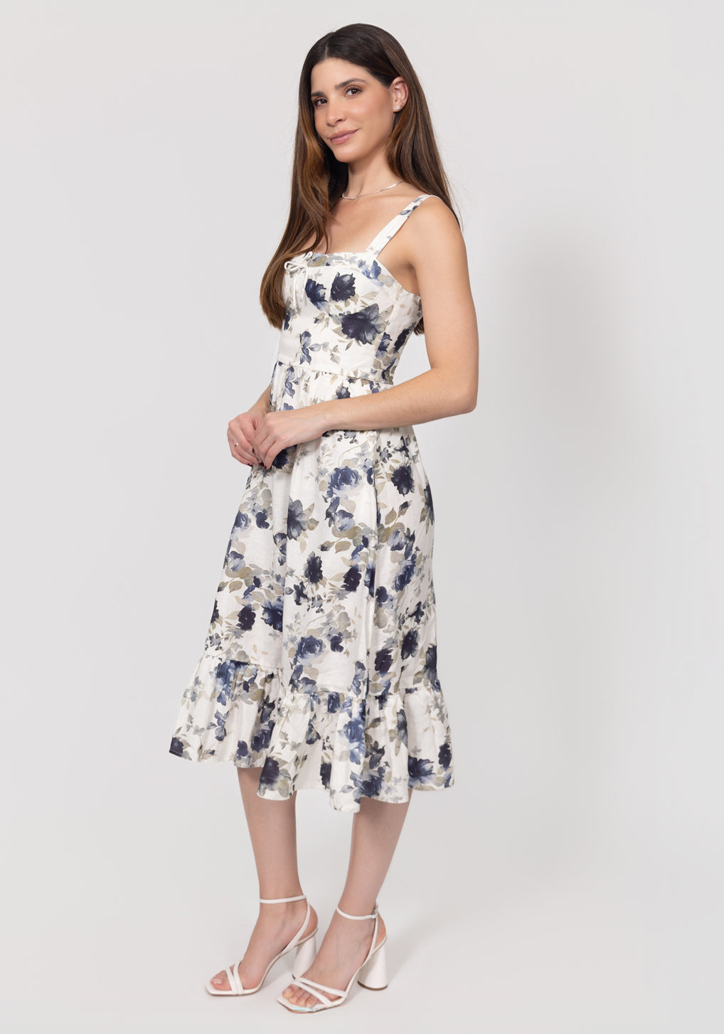 Woman wearing a floral Romantic Linen Midi Dress With Front Tie & Soft Ruffle on a white background