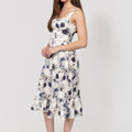 Woman wearing a floral Romantic Linen Midi Dress With Front Tie & Soft Ruffle on a white background