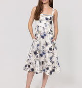Woman wearing a floral Romantic Linen Midi Dress With Front Tie & Soft Ruffle on a white background