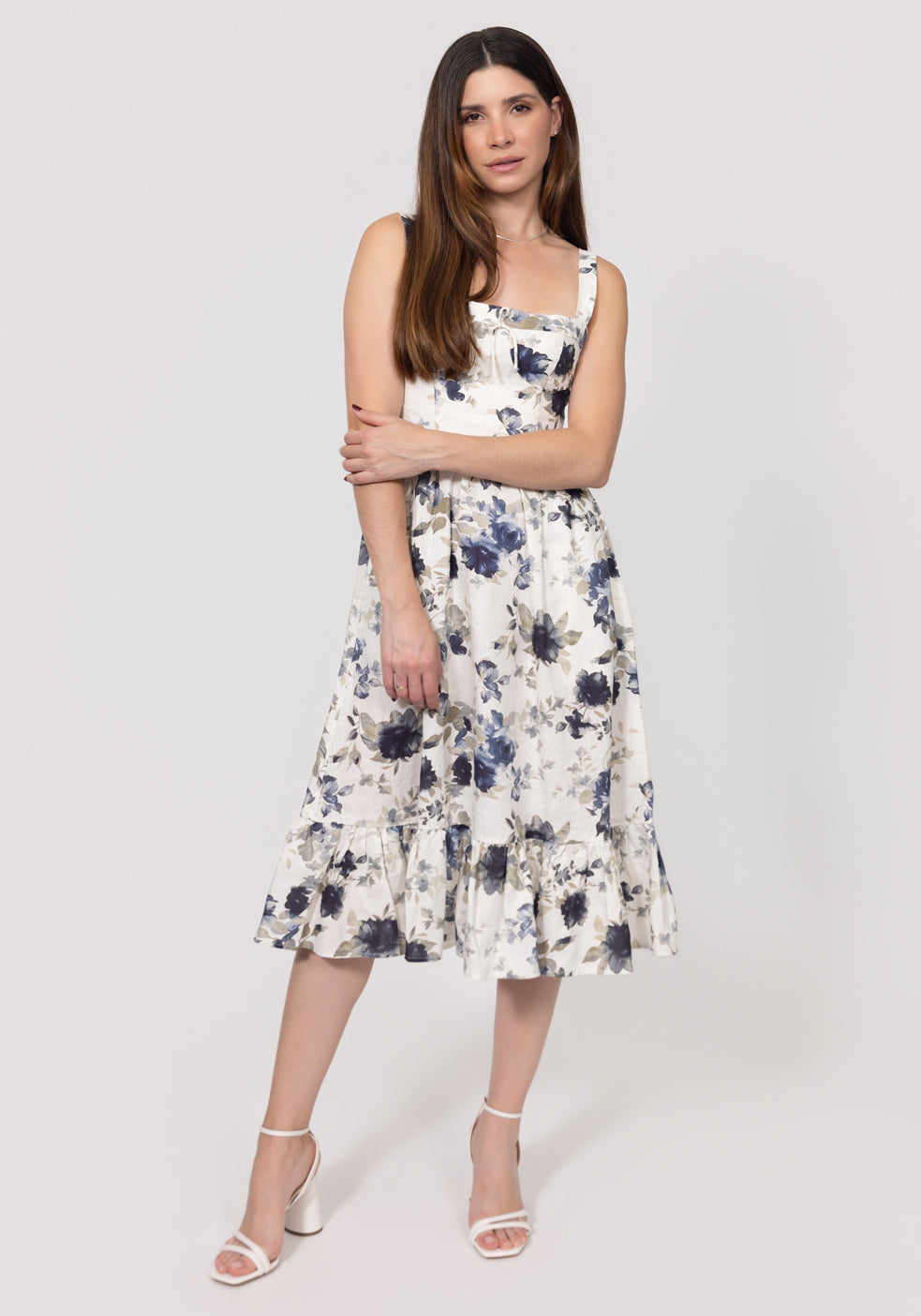 Woman wearing a floral Romantic Linen Midi Dress With Front Tie & Soft Ruffle on a white background