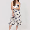 Woman wearing a floral Romantic Linen Midi Dress With Front Tie & Soft Ruffle on a white background