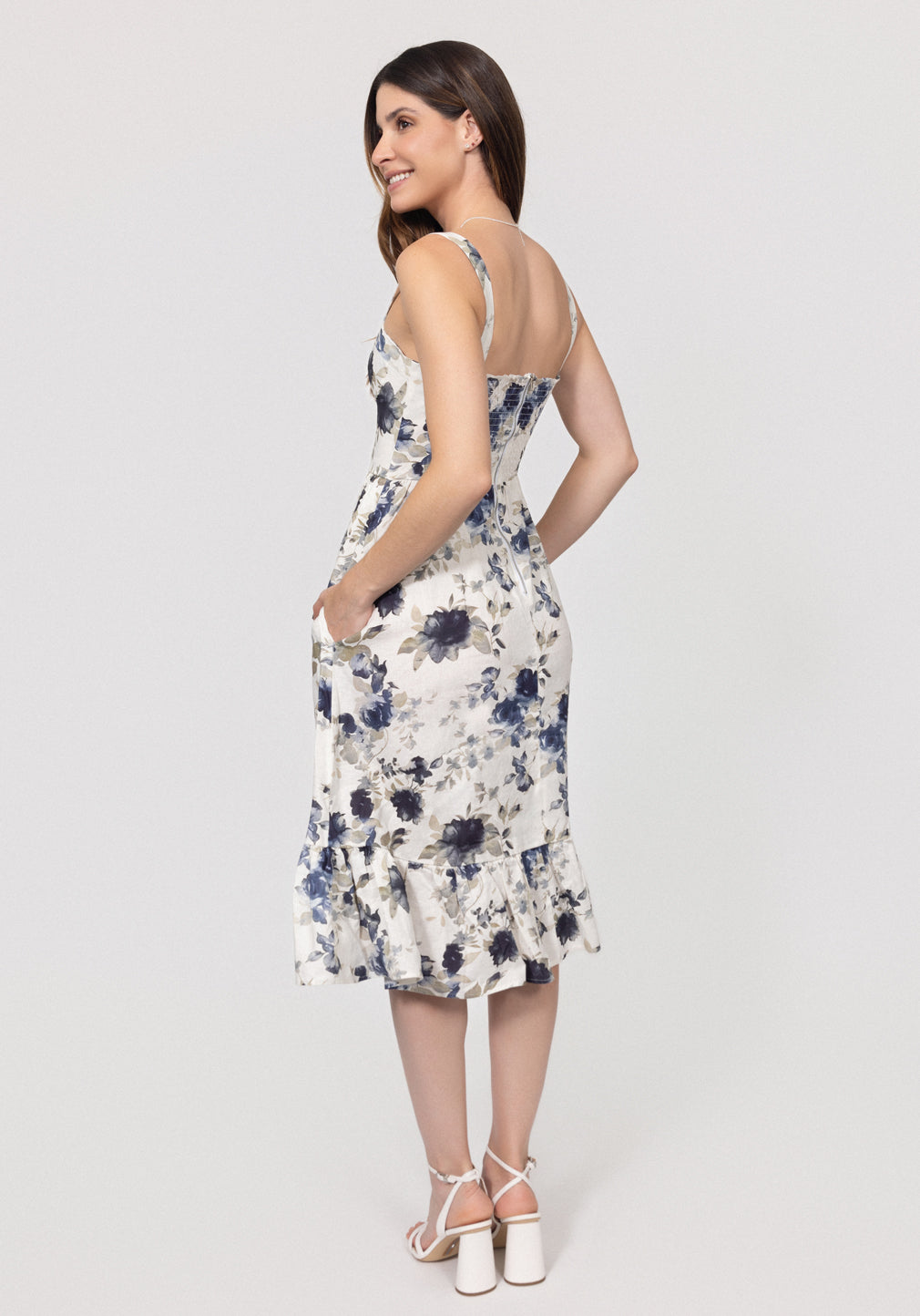 Woman wearing a floral Romantic Linen Midi Dress With Front Tie & Soft Ruffle on a white background
