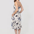 Woman wearing a floral Romantic Linen Midi Dress With Front Tie & Soft Ruffle on a white background