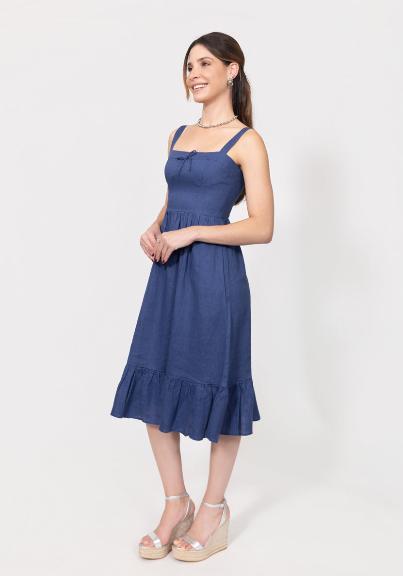 Woman wearing a blue Romantic Linen Midi Dress With Front Tie & Soft Ruffle on a white background